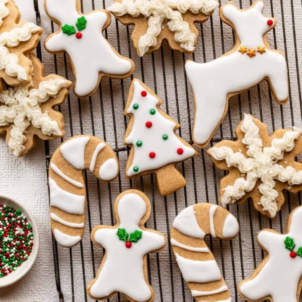 decorated brown sugar cut-out cookies in various shapes including reindeer, candy canes, and snowflakes.