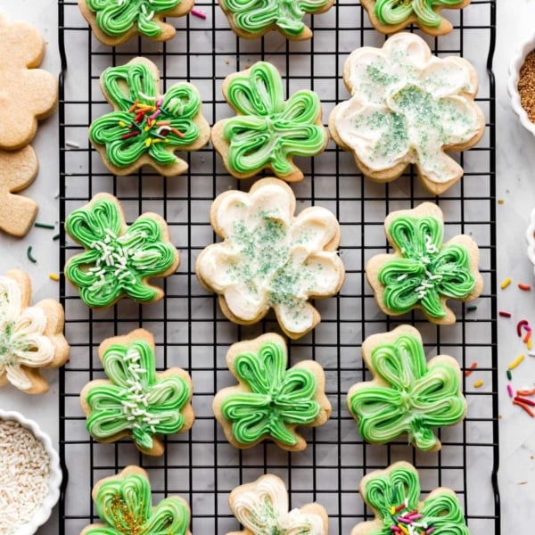 shamrock shaped sugar cookies with green and white buttercream frosting